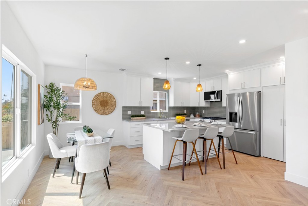 3937 2nd Avenue Los Angeles, CA 90008 - Photo 11 of 47 a kitchen with a dining table and chairs
