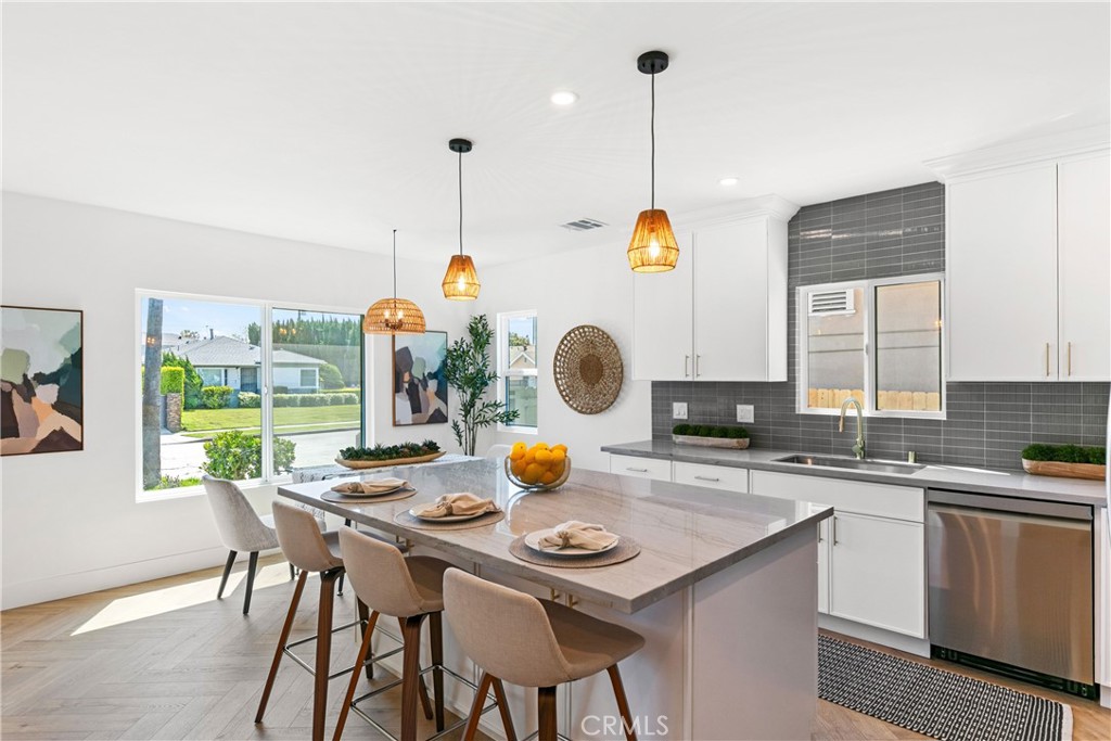 3937 2nd Avenue Los Angeles, CA 90008 - Photo 12 of 47 a kitchen with a sink a counter and chairs