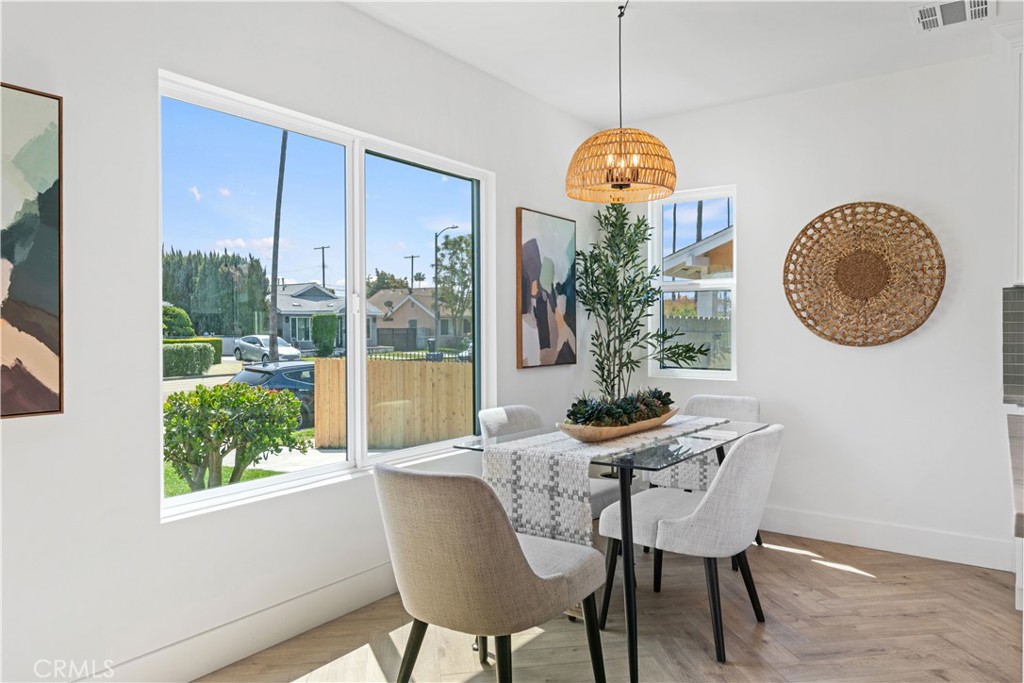 3937 2nd Avenue Los Angeles, CA 90008 - Photo 13 of 47 a dining room with furniture a window and a chandelier