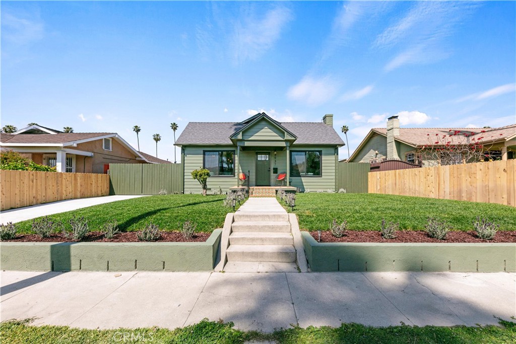 3937 2nd Avenue Los Angeles, CA 90008 - Photo 2 of 47 a front view of a house with a yard and potted plants