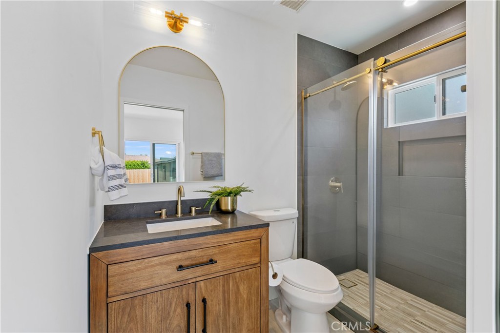 3937 2nd Avenue Los Angeles, CA 90008 - Photo 26 of 47 a bathroom with a toilet sink and mirror