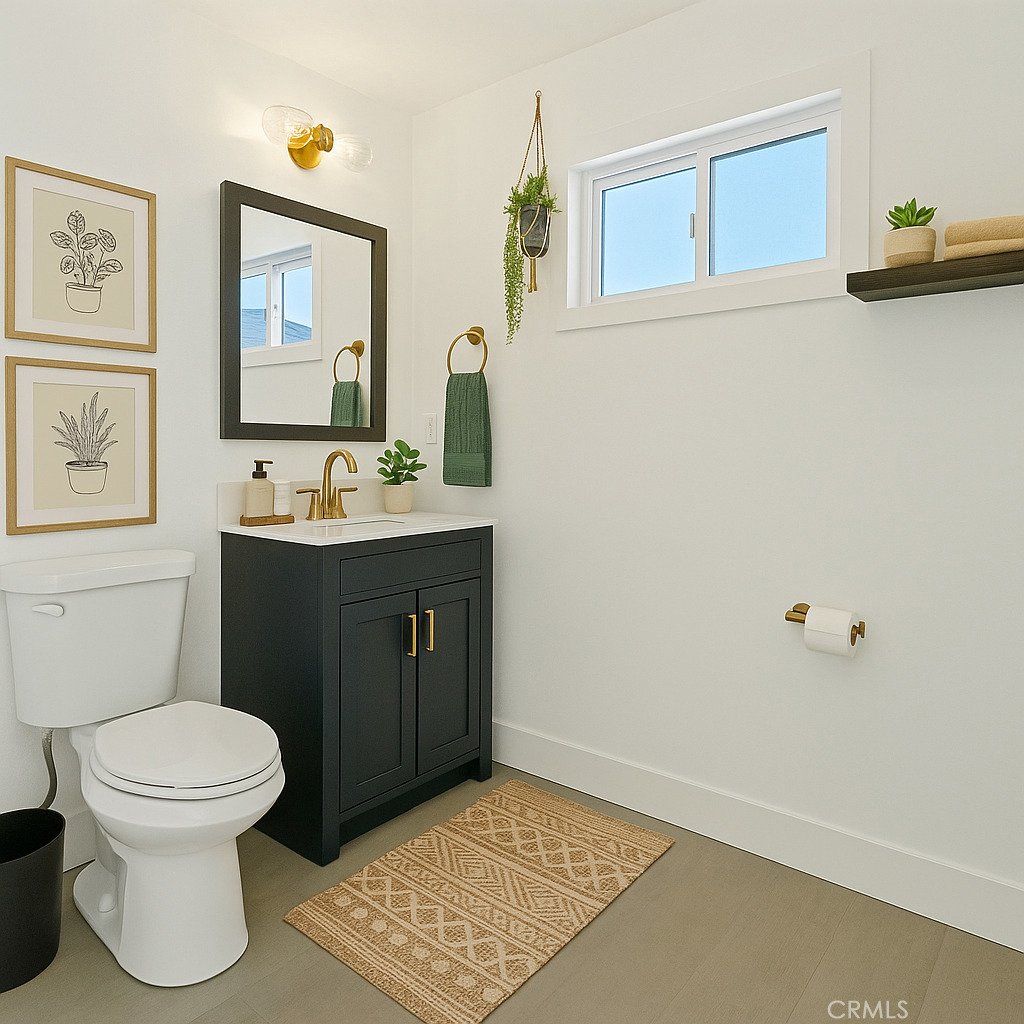 3937 2nd Avenue Los Angeles, CA 90008 - Photo 31 of 47 a bathroom with a toilet a sink and mirror