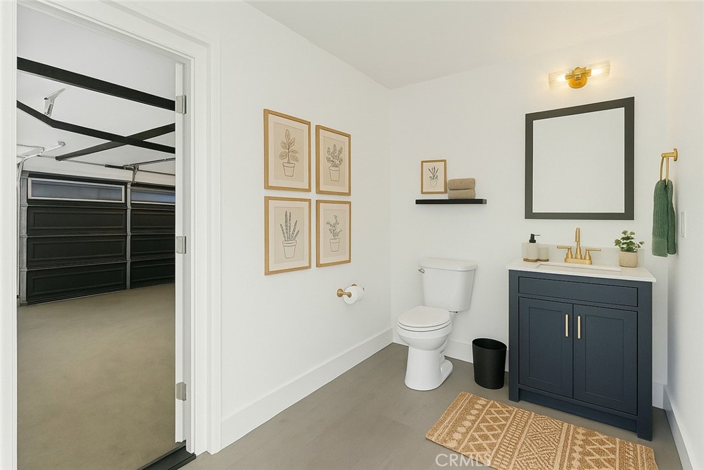 3937 2nd Avenue Los Angeles, CA 90008 - Photo 32 of 47 a bathroom with a toilet sink and mirror