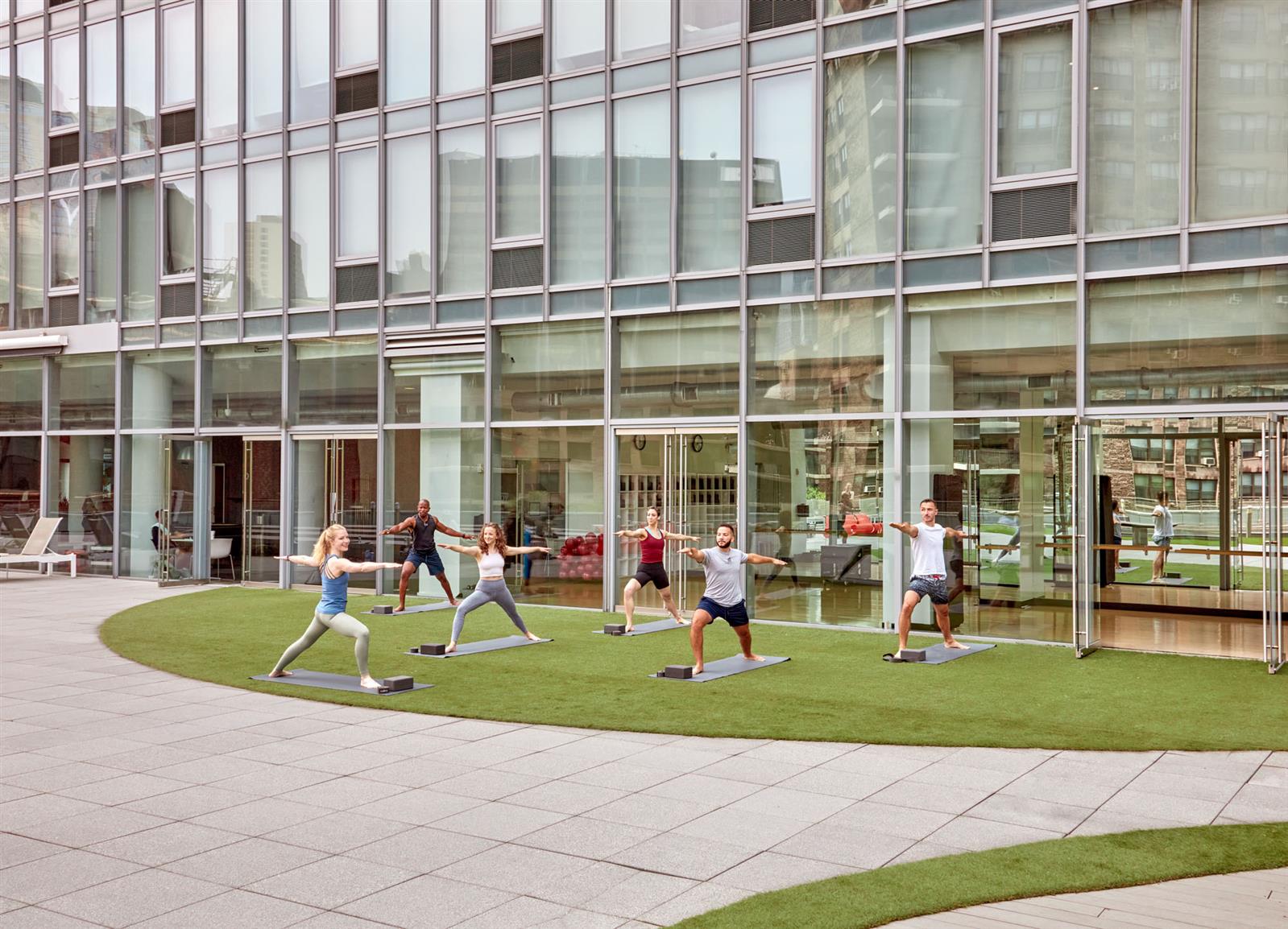 550 West 54th Street, Unit 952 Manhattan, NY 10019 - Photo 12 of 27 a group of people sitting in front of a building