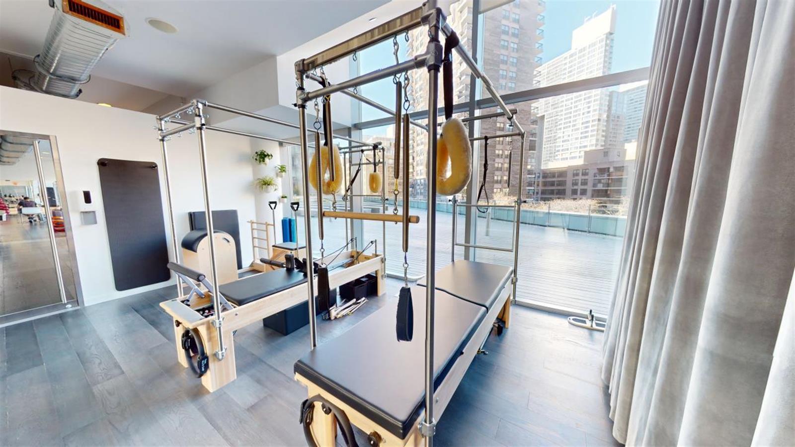 550 West 54th Street, Unit 952 Manhattan, NY 10019 - Photo 14 of 27 a living room with furniture and a window