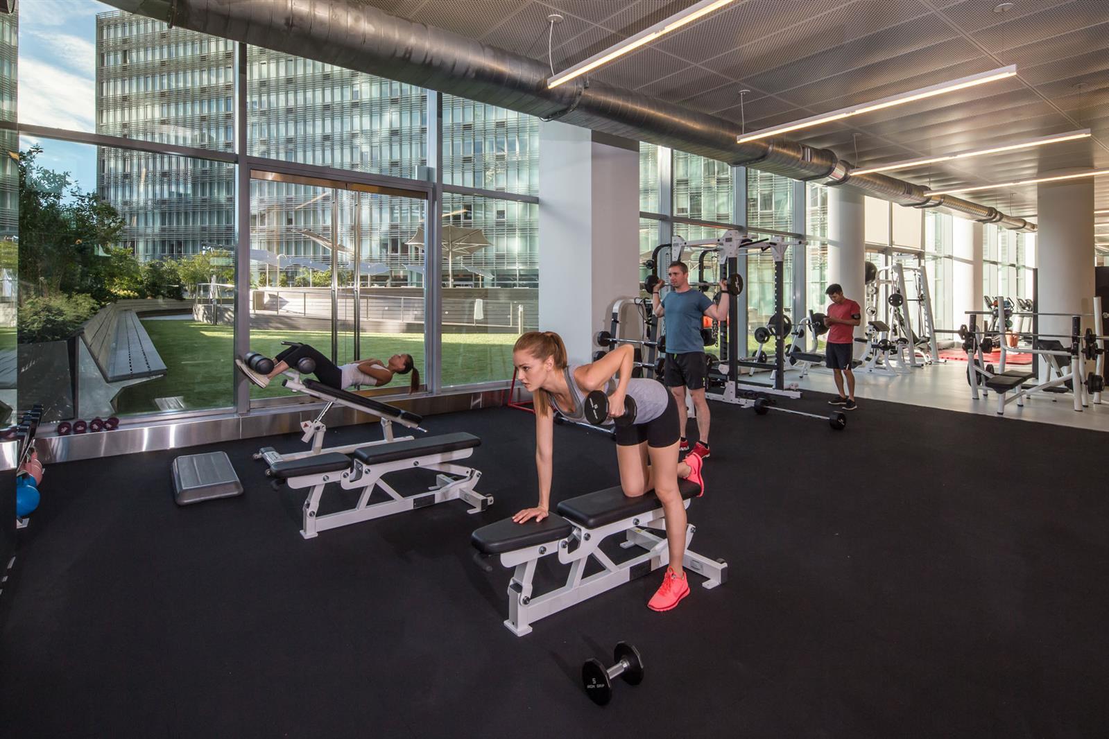 550 West 54th Street, Unit 952 Manhattan, NY 10019 - Photo 9 of 27 a room with gym equipment and a large window