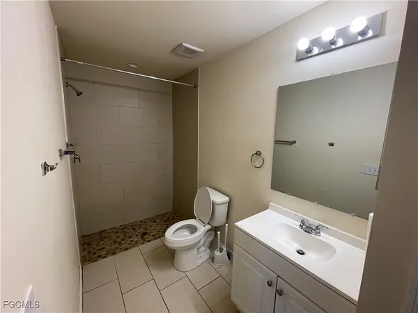 a bathroom with a sink a toilet and a shower