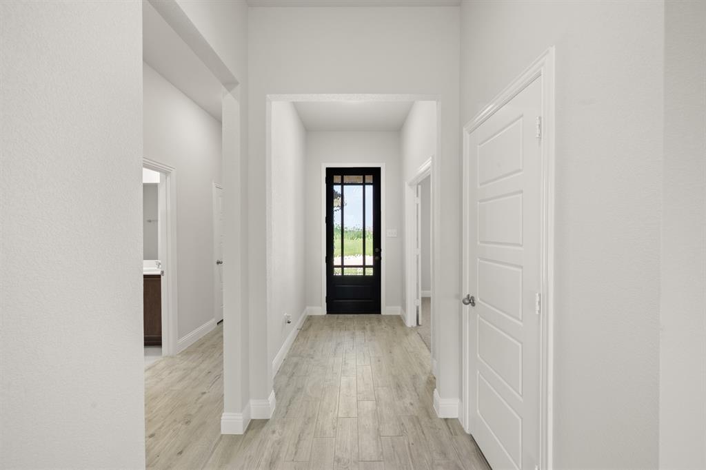 228 Shepards Street Godley, TX 76044 - Photo 14 of 27 a view of a hallway with wooden floor and closet