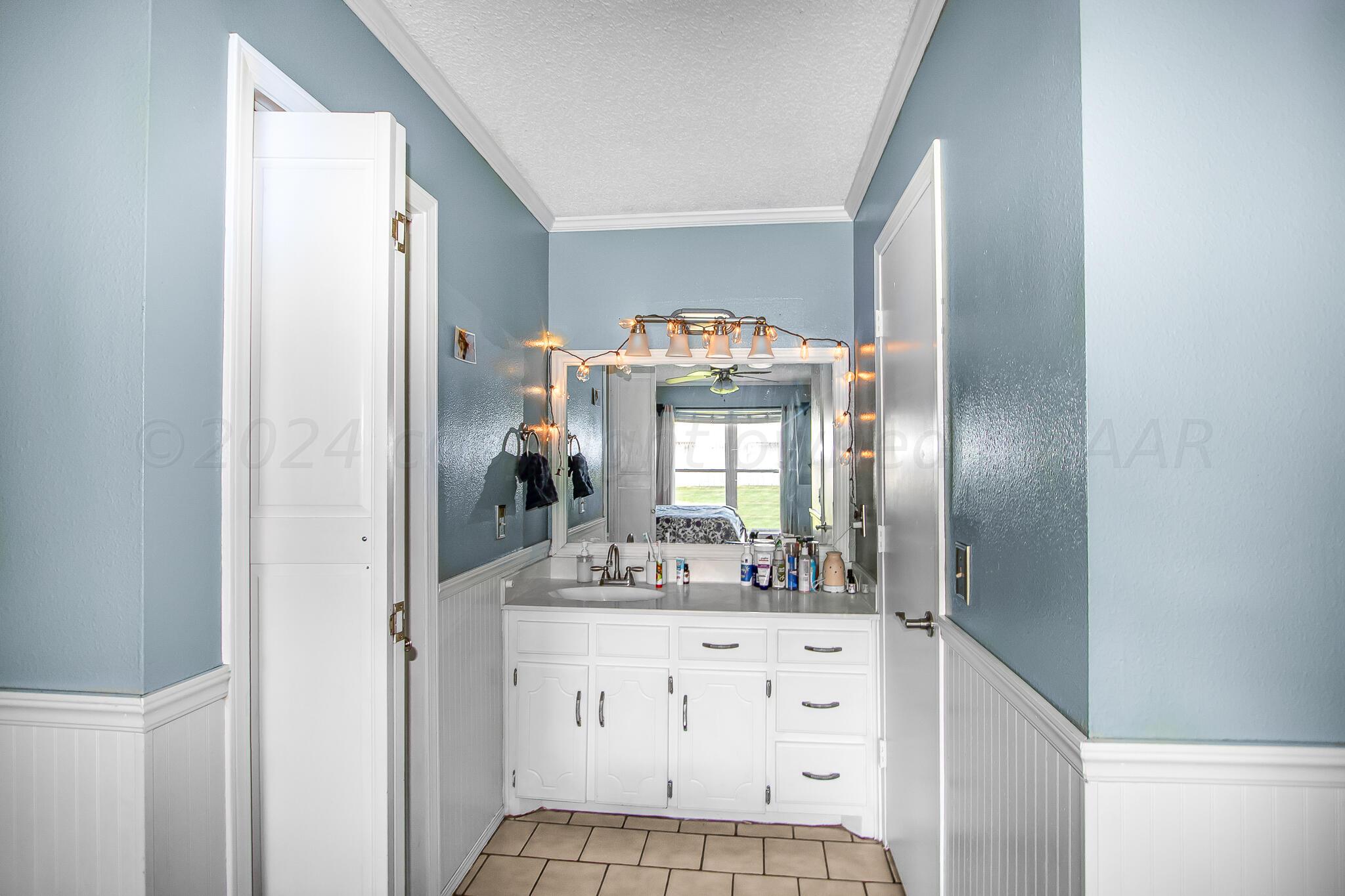 2208 Gresham Drive Amarillo, TX 79110 - Photo 18 of 31 a bathroom with a sink and a mirror