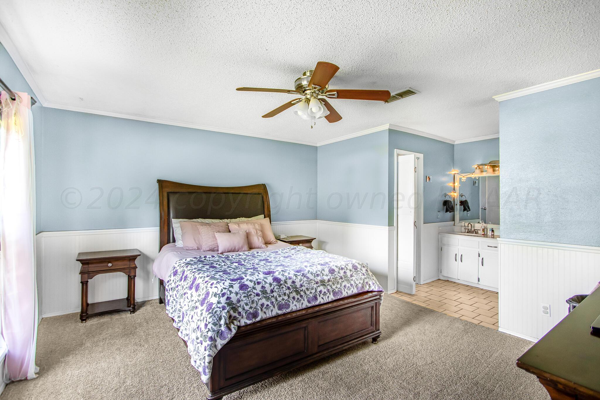 2208 Gresham Drive Amarillo, TX 79110 - Photo 19 of 31 a bedroom with a bed and a chandelier