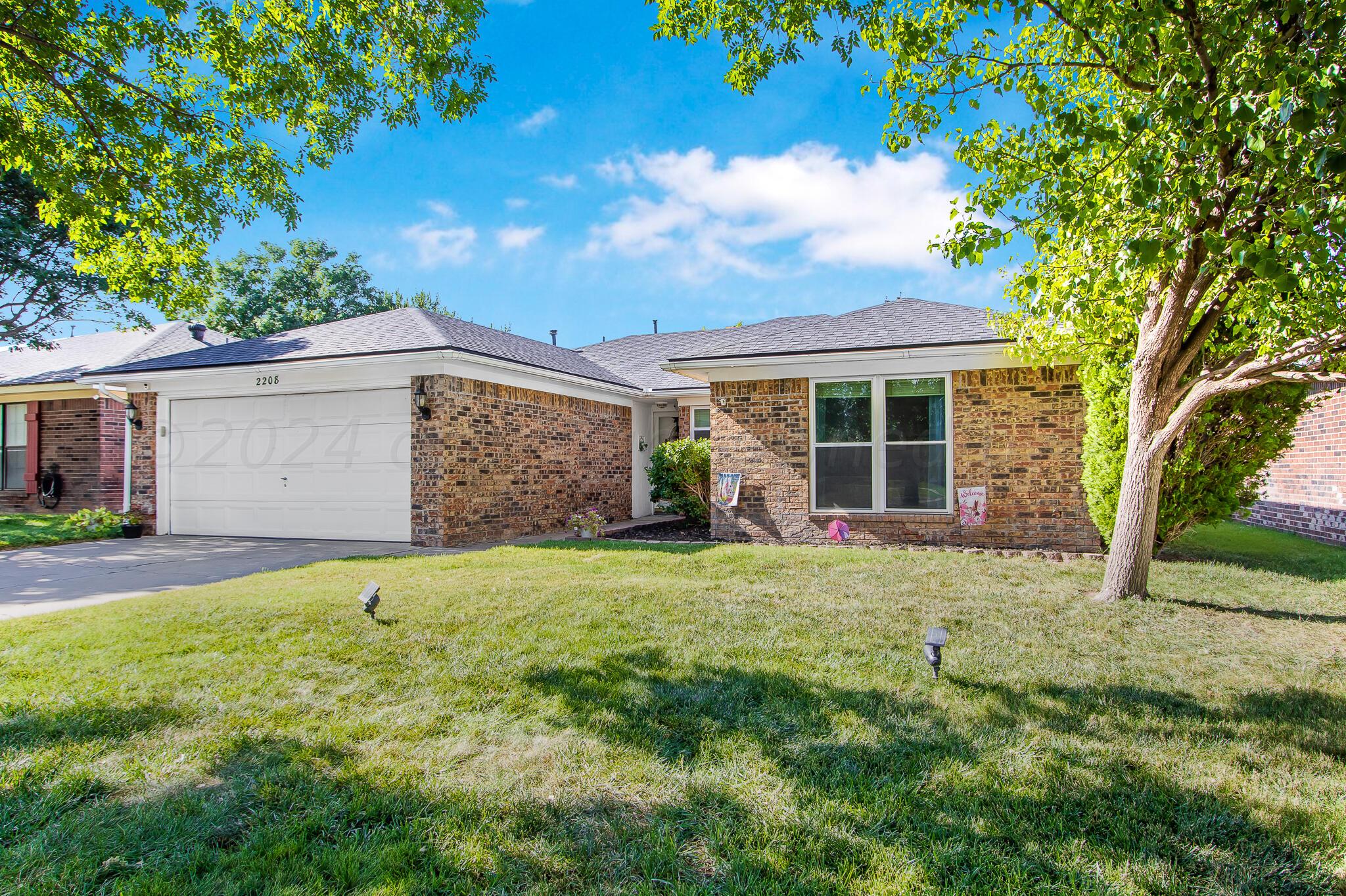 2208 Gresham Drive Amarillo, TX 79110 - Photo 2 of 31 a front view of a house with a yard and garage