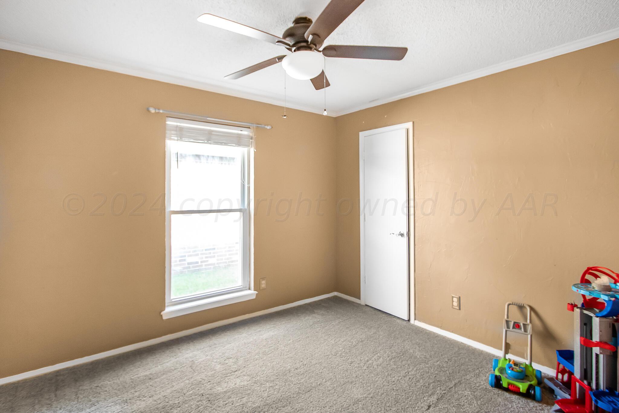 2208 Gresham Drive Amarillo, TX 79110 - Photo 22 of 31 a view of an empty room with a window