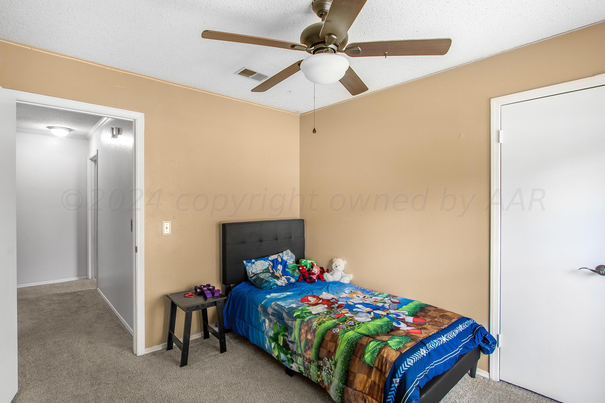 2208 Gresham Drive Amarillo, TX 79110 - Photo 24 of 31 a bedroom with a bed and a table in it