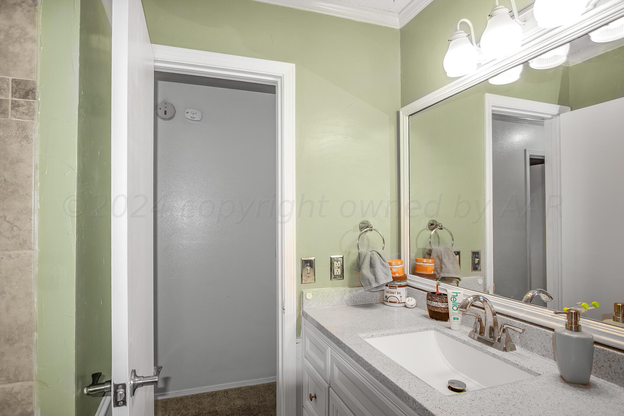 2208 Gresham Drive Amarillo, TX 79110 - Photo 27 of 31 a bathroom with a double vanity sink mirror and