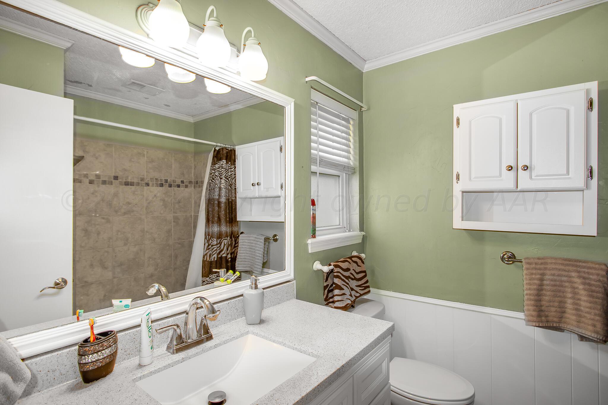 2208 Gresham Drive Amarillo, TX 79110 - Photo 28 of 31 a bathroom with a sink toilet and shower