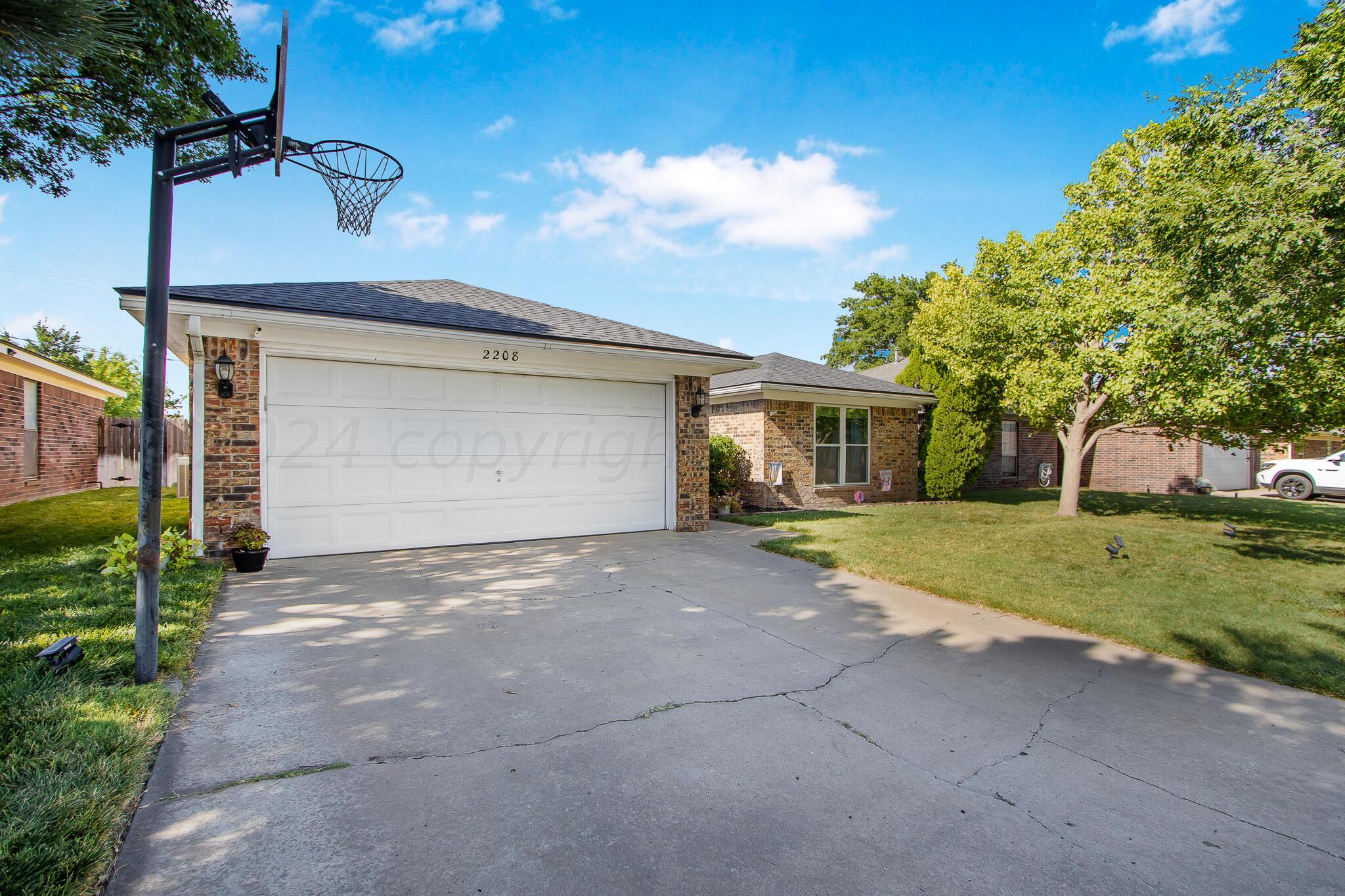2208 Gresham Drive Amarillo, TX 79110 - Photo 3 of 31 a view of a house with a yard and garage