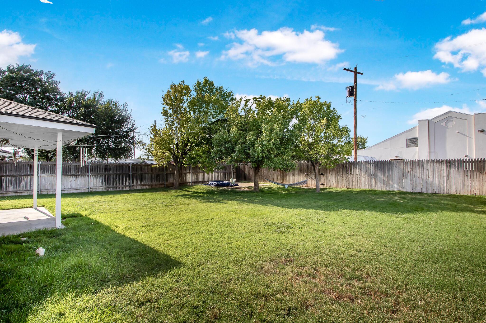 2208 Gresham Drive Amarillo, TX 79110 - Photo 31 of 31 a view of a house with a yard and sitting area