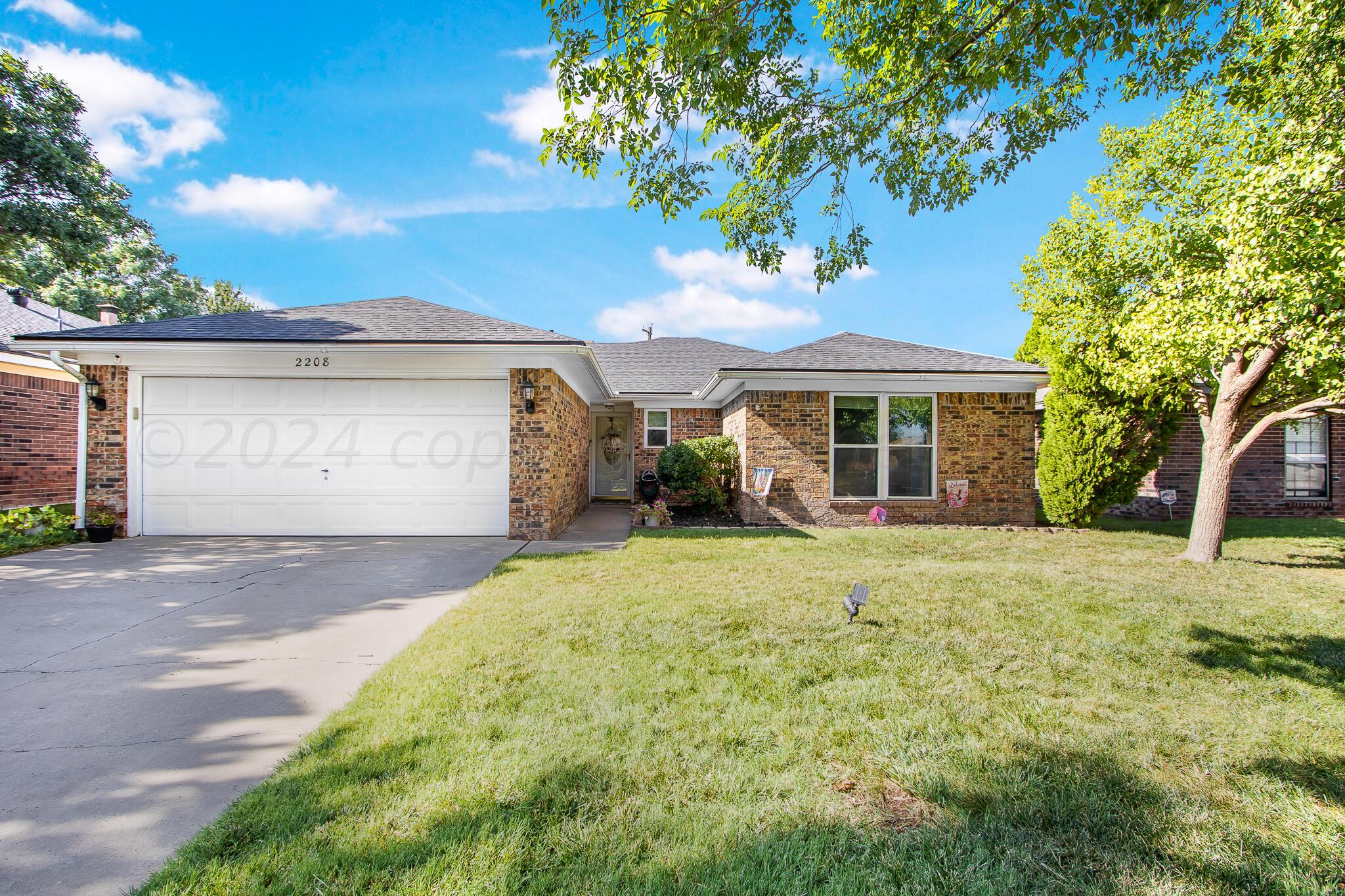2208 Gresham Drive Amarillo, TX 79110 - Photo 4 of 31 a front view of a house with garden
