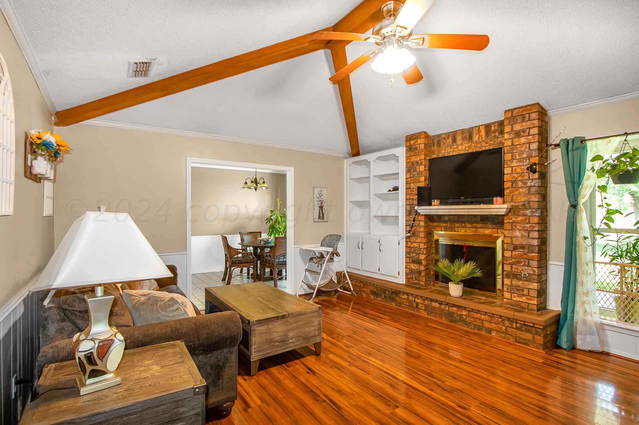2208 Gresham Drive Amarillo, TX 79110 - Photo 6 of 31 a living room with furniture and a fireplace