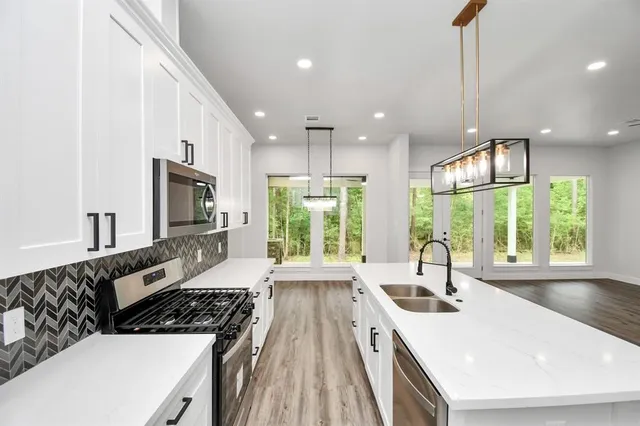 a kitchen with a large window in it and kitchen island
