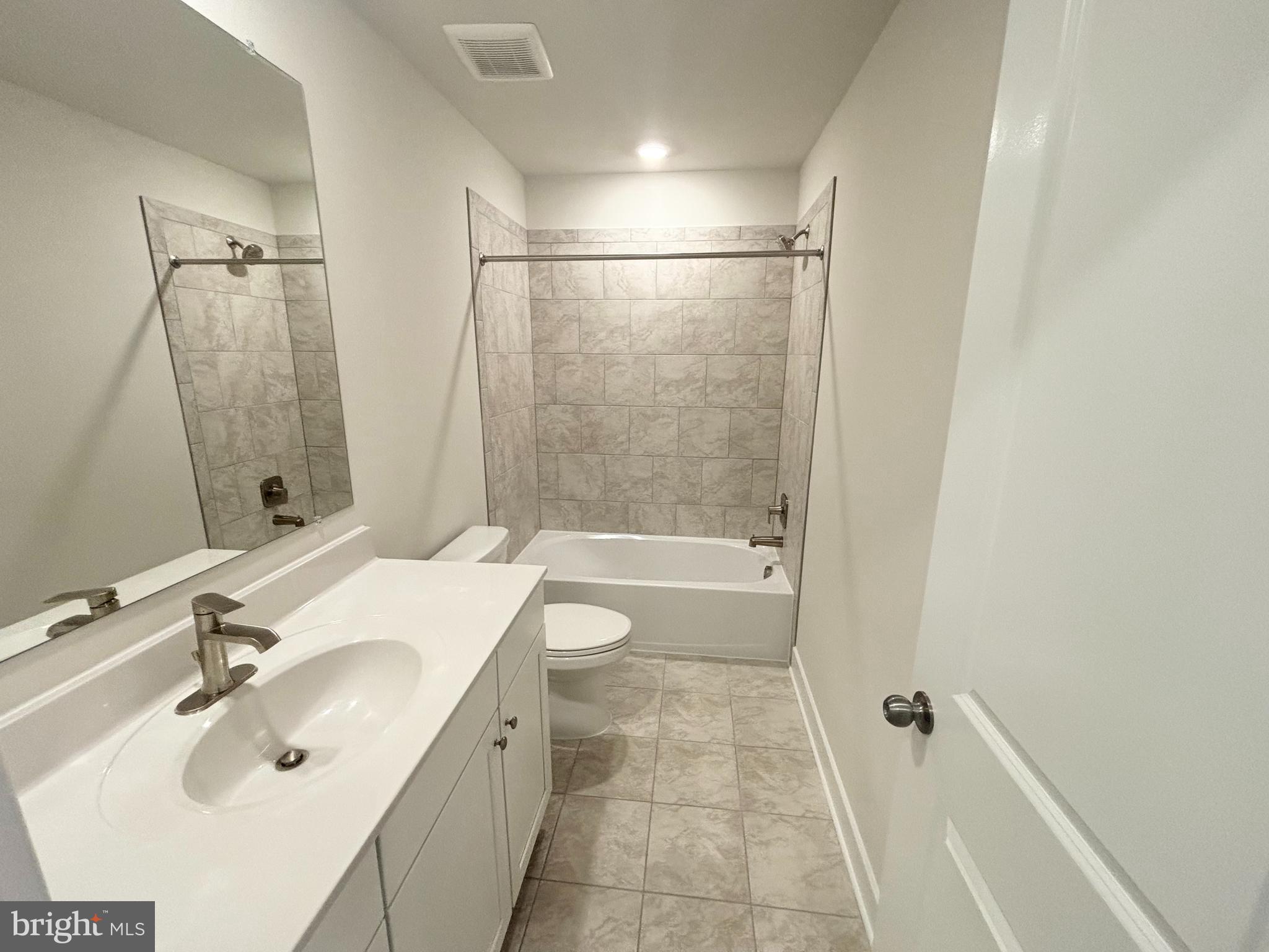 7260 Contee Road Laurel, MD 20707 - Photo 12 of 13 a bathroom with a sink mirror toilet and bathtub
