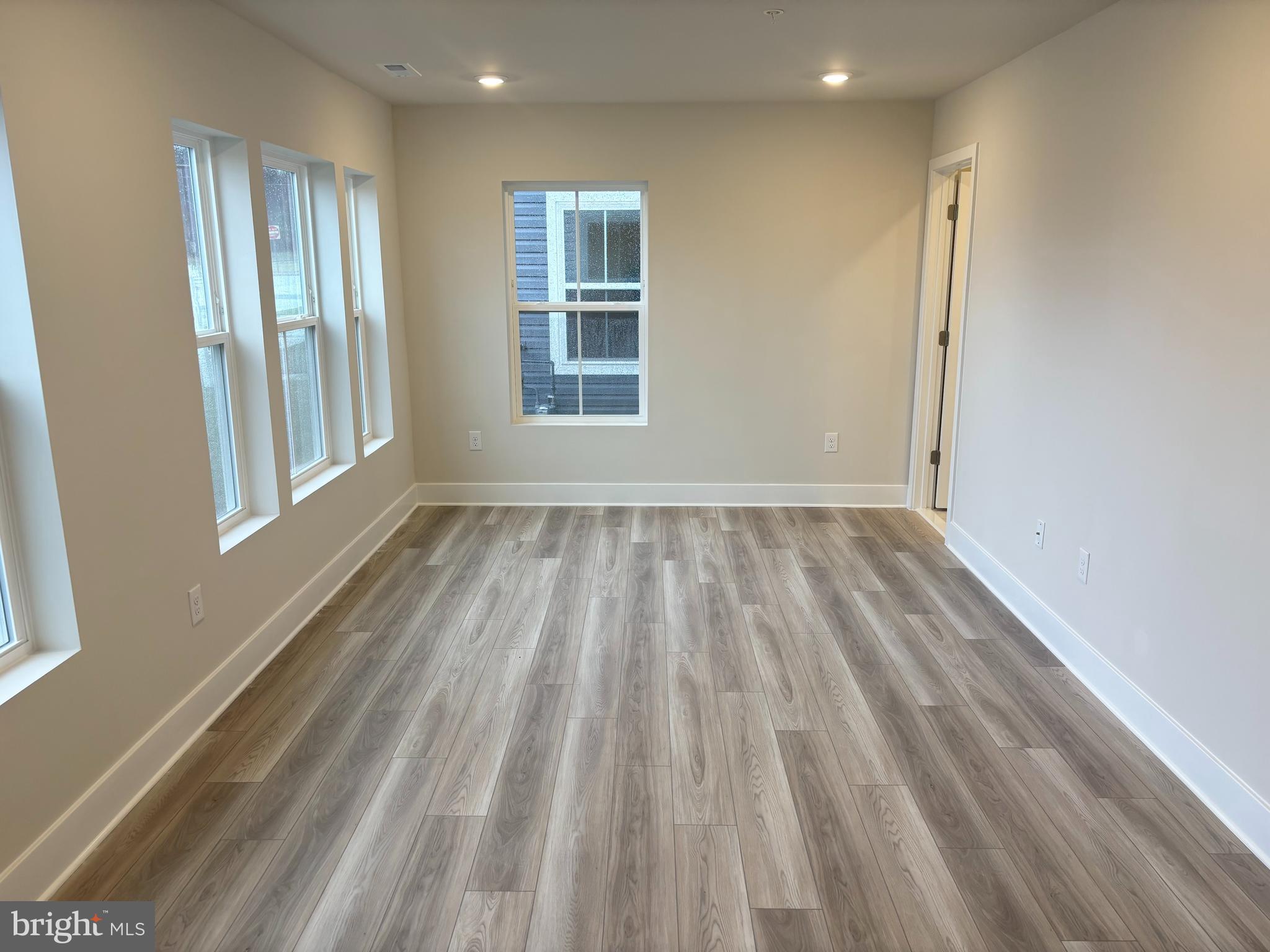 7260 Contee Road Laurel, MD 20707 - Photo 2 of 13 an empty room with wooden floor and windows