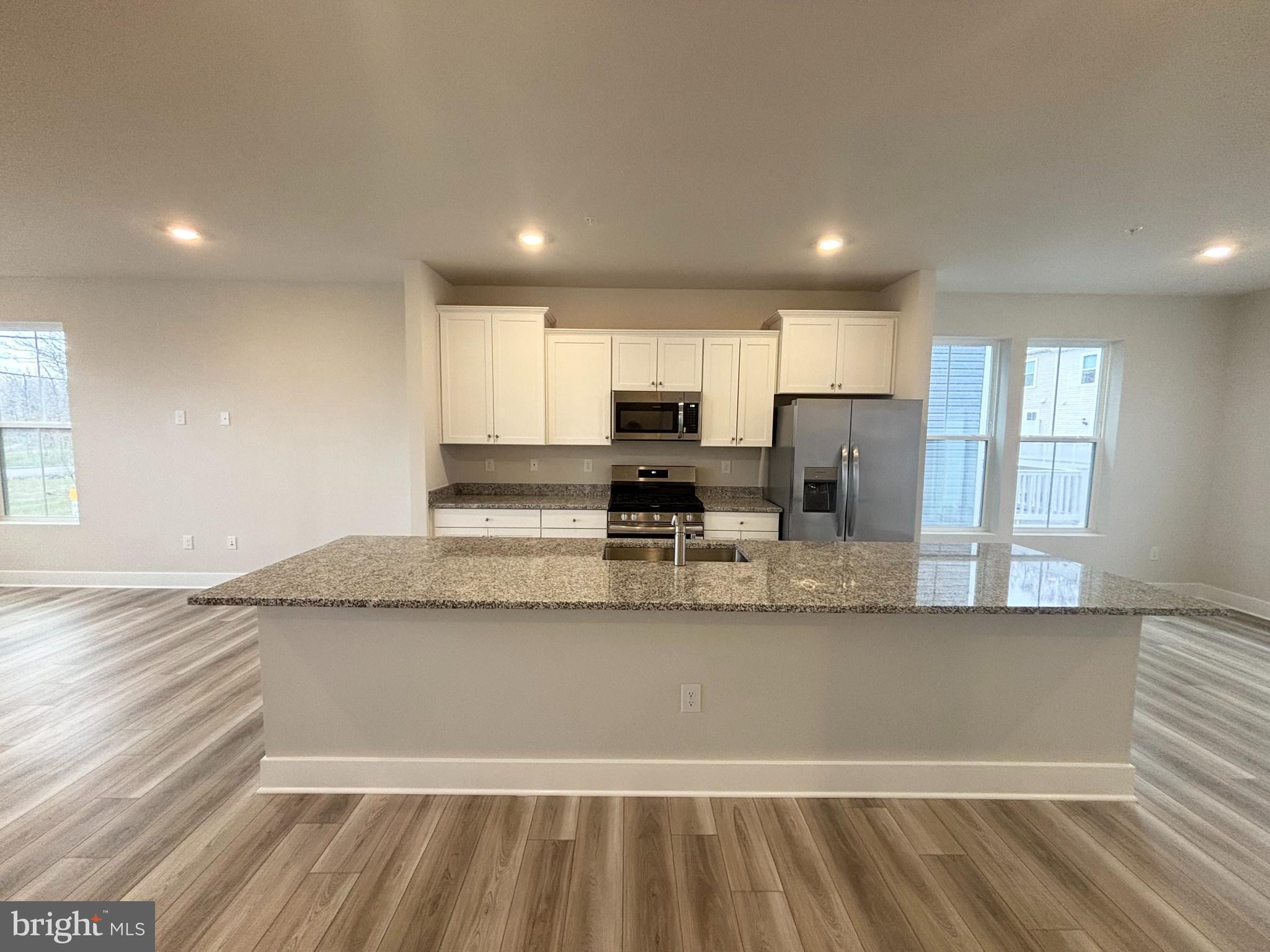 7260 Contee Road Laurel, MD 20707 - Photo 3 of 13 a large kitchen with granite countertop a large counter top stainless steel appliances and cabinets