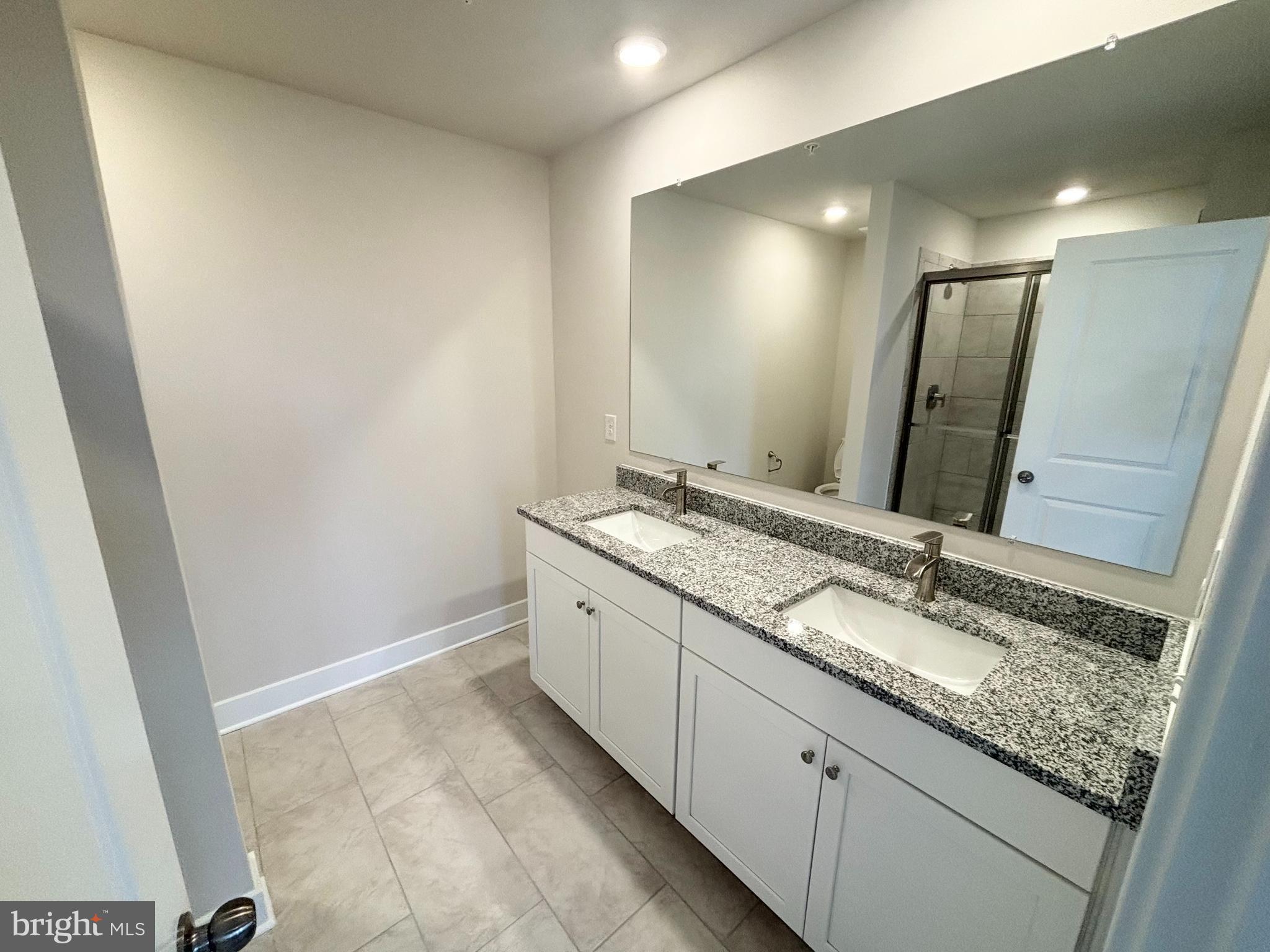 7260 Contee Road Laurel, MD 20707 - Photo 8 of 13 a bathroom with a granite countertop sink and a mirror
