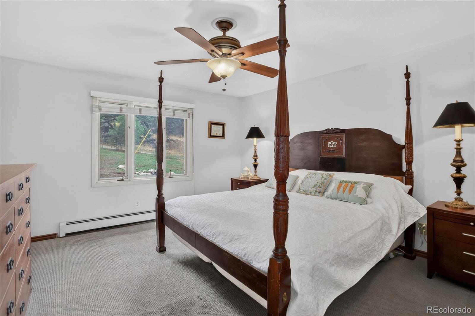 12699 South Foxton Road Conifer, CO 80433 - Photo 13 of 40 a bedroom with a bed and window