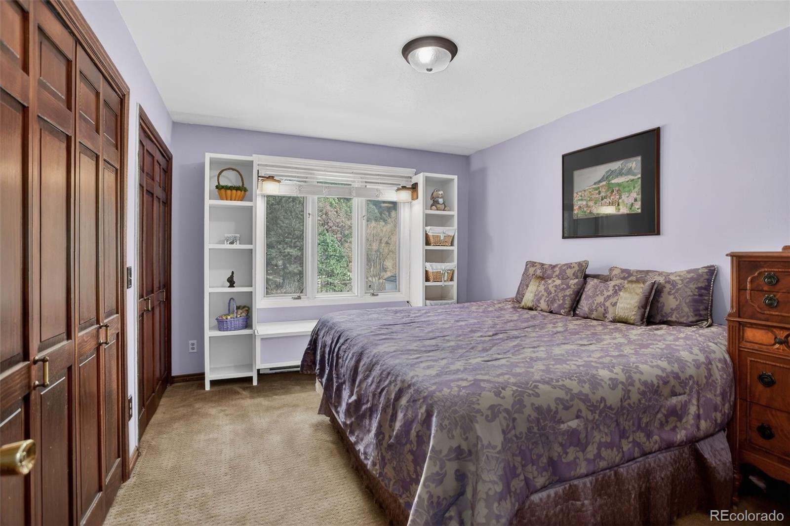 12699 South Foxton Road Conifer, CO 80433 - Photo 17 of 40 a bed sitting in a bedroom next to a window
