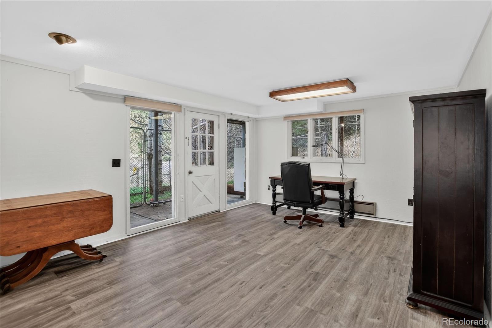 12699 South Foxton Road Conifer, CO 80433 - Photo 22 of 40 a living room with furniture and a wooden floor