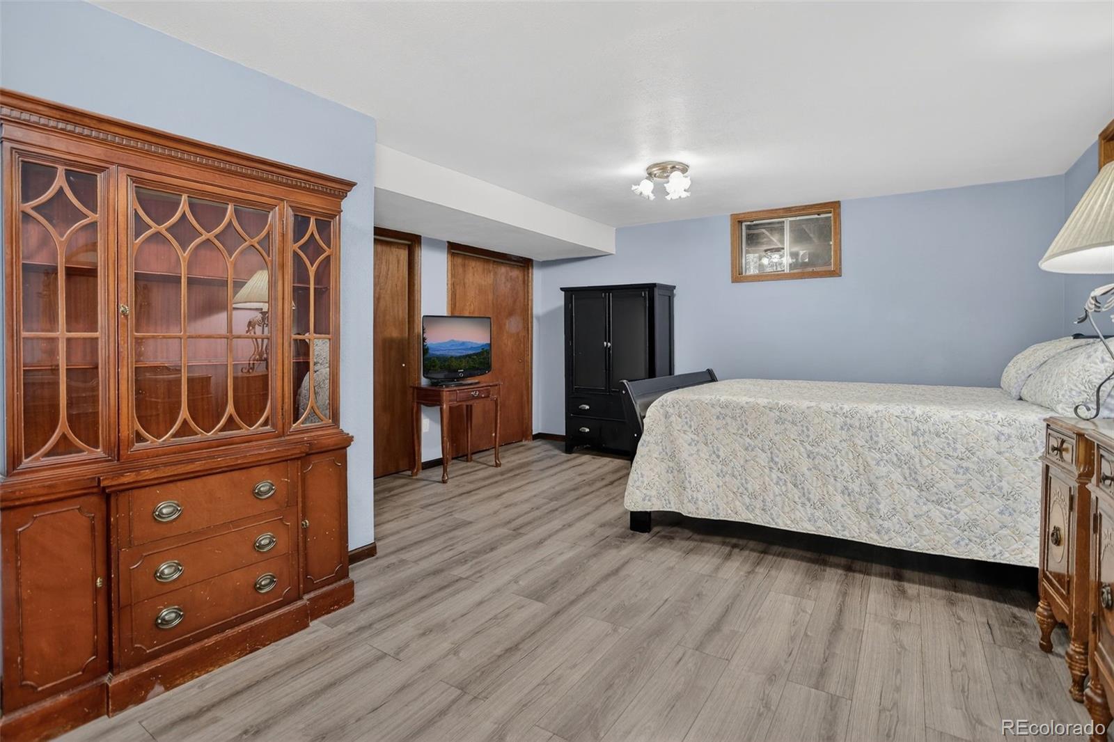 12699 South Foxton Road Conifer, CO 80433 - Photo 24 of 40 a bedroom with a bed and wooden floor