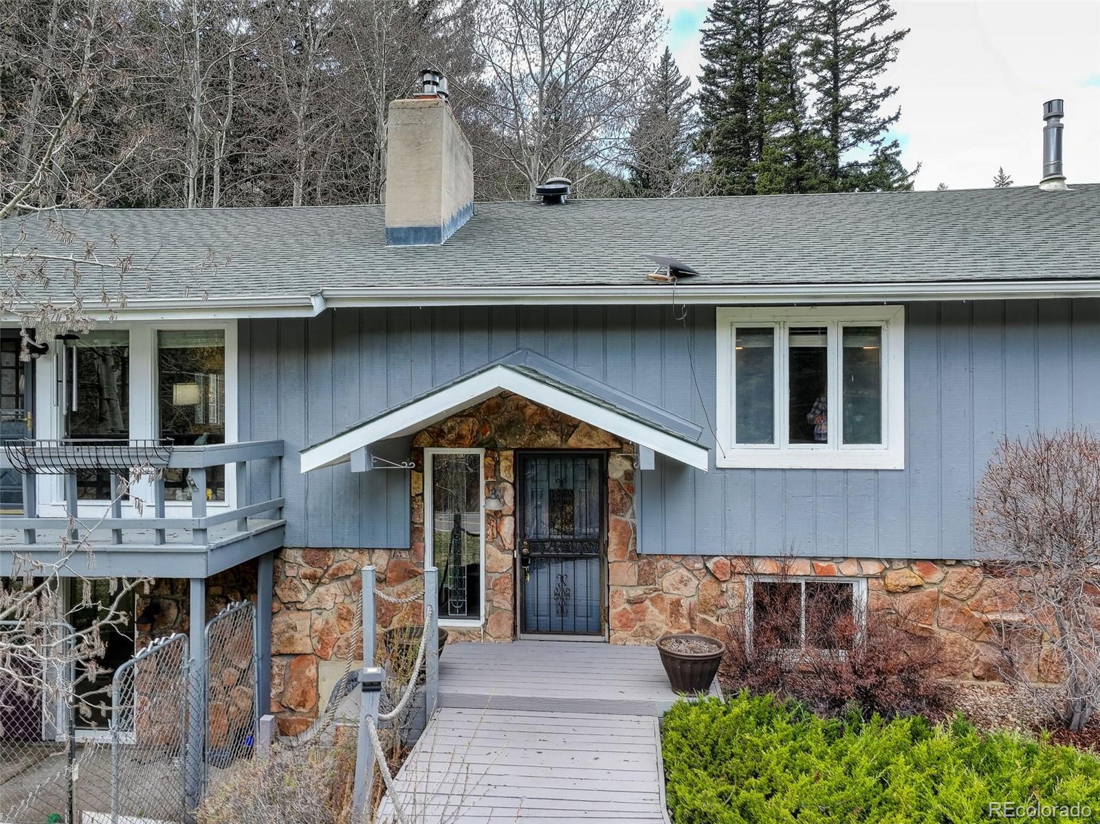 12699 South Foxton Road Conifer, CO 80433 - Photo 28 of 40 a front view of a house with garden