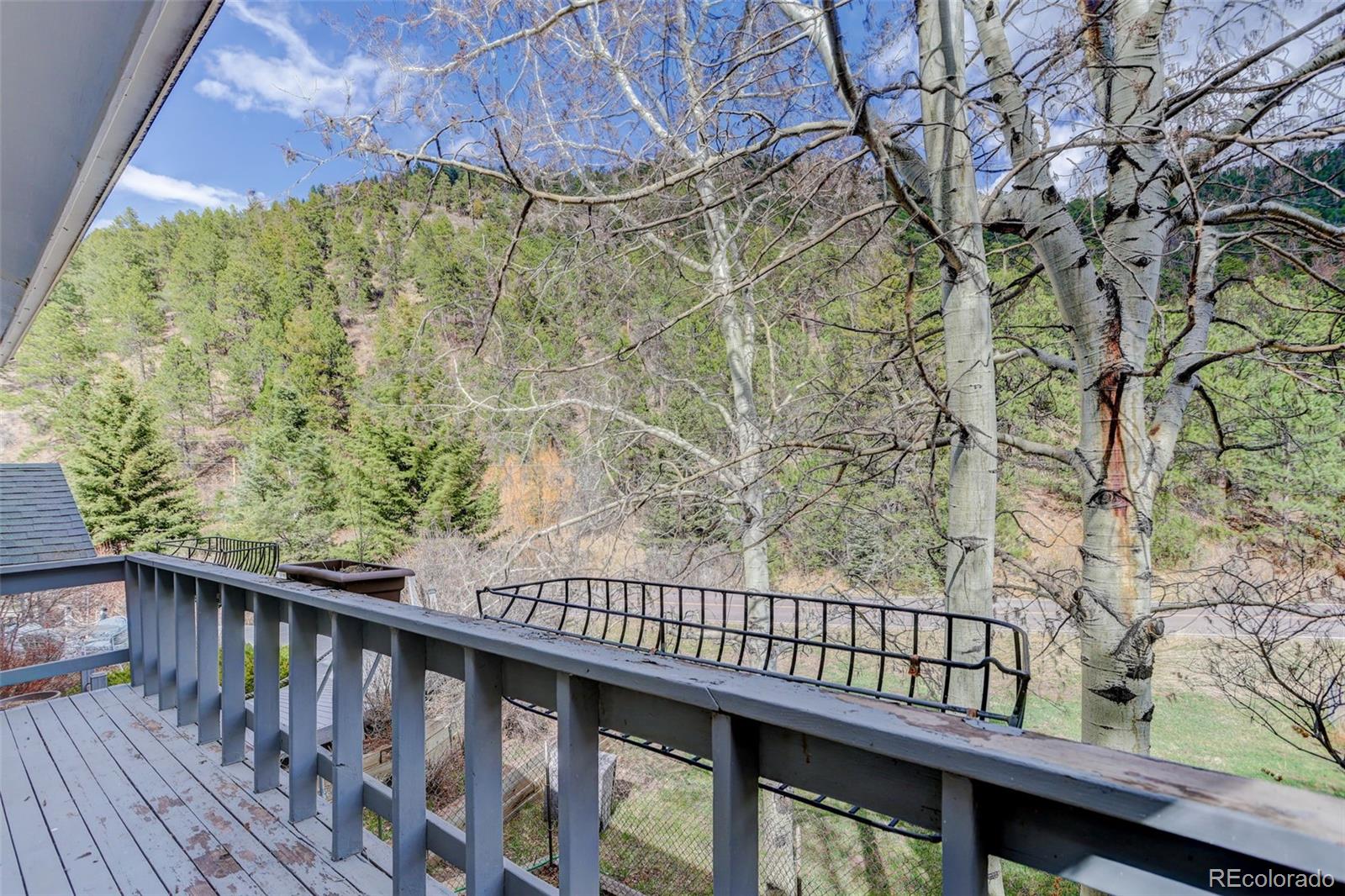 12699 South Foxton Road Conifer, CO 80433 - Photo 30 of 40 a balcony with wooden floor and outdoor space