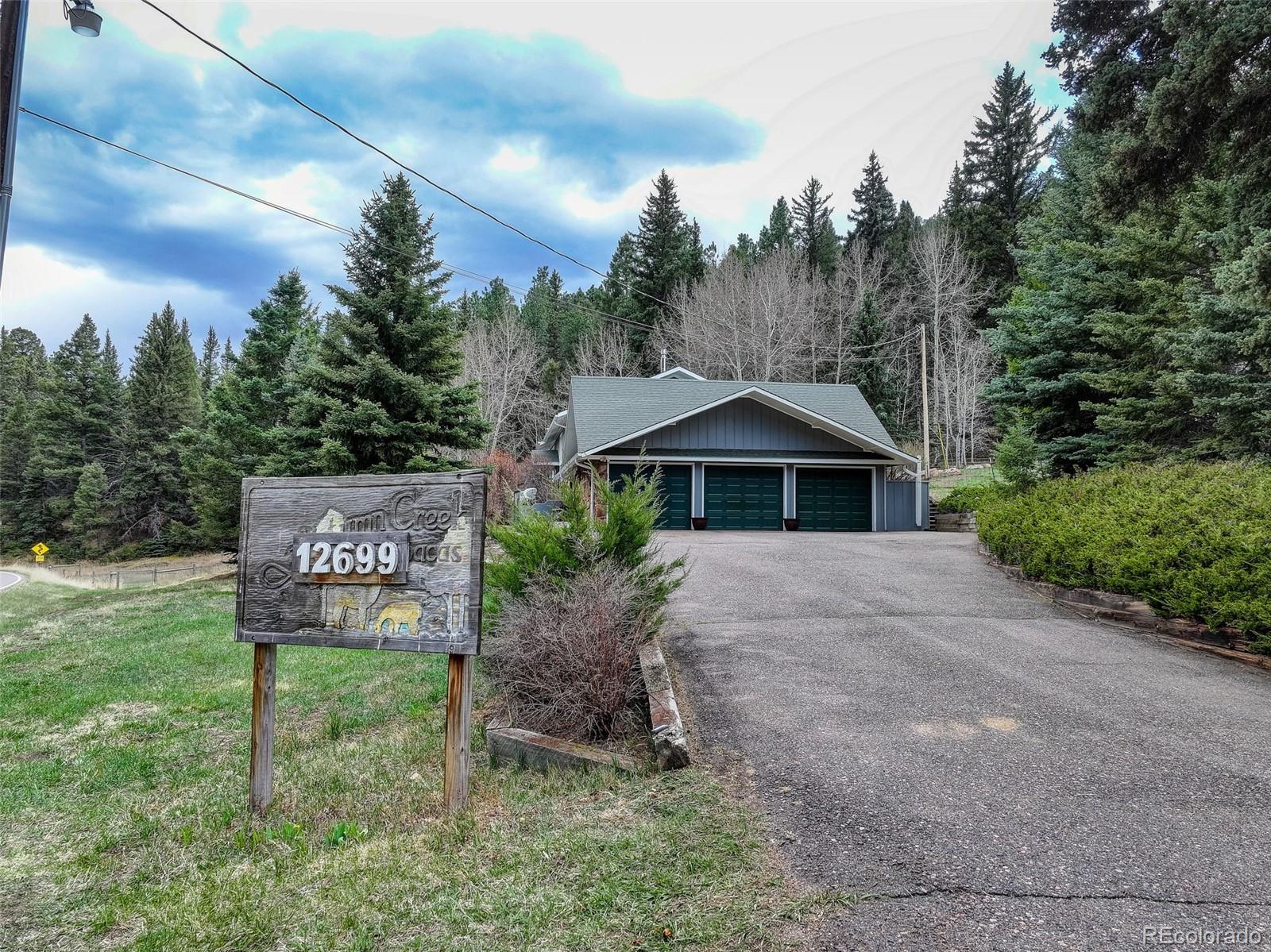 12699 South Foxton Road Conifer, CO 80433 - Photo 36 of 40 a front view of a house with garden