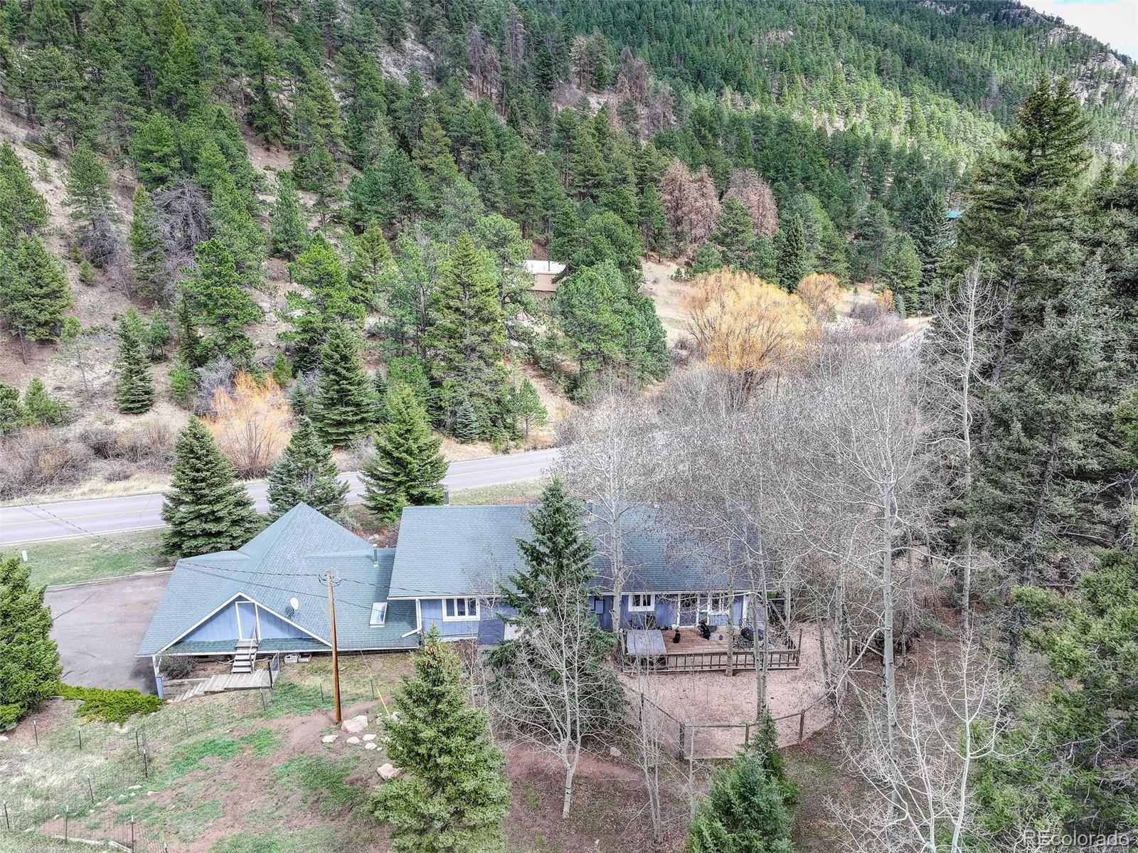12699 South Foxton Road Conifer, CO 80433 - Photo 37 of 40 an aerial view of a house with yard and mountain view in back