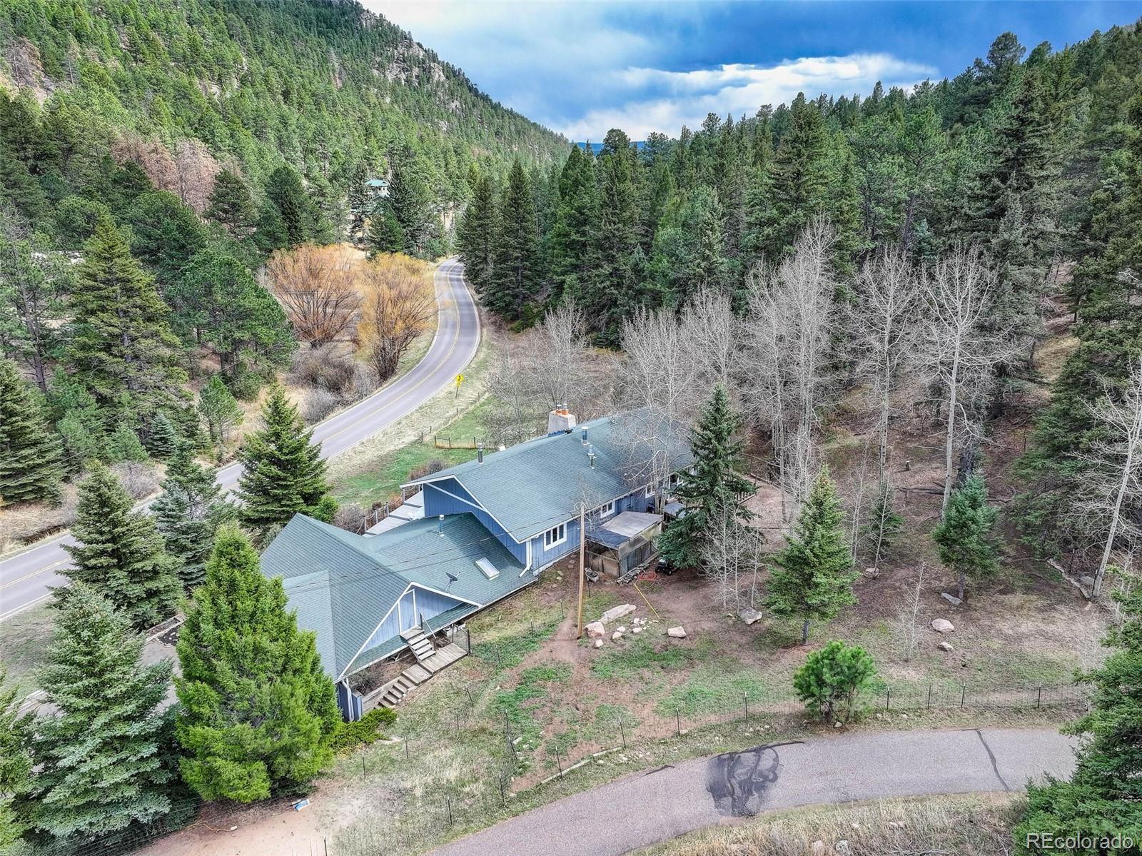 12699 South Foxton Road Conifer, CO 80433 - Photo 38 of 40 an aerial view of a house with yard and outdoor seating