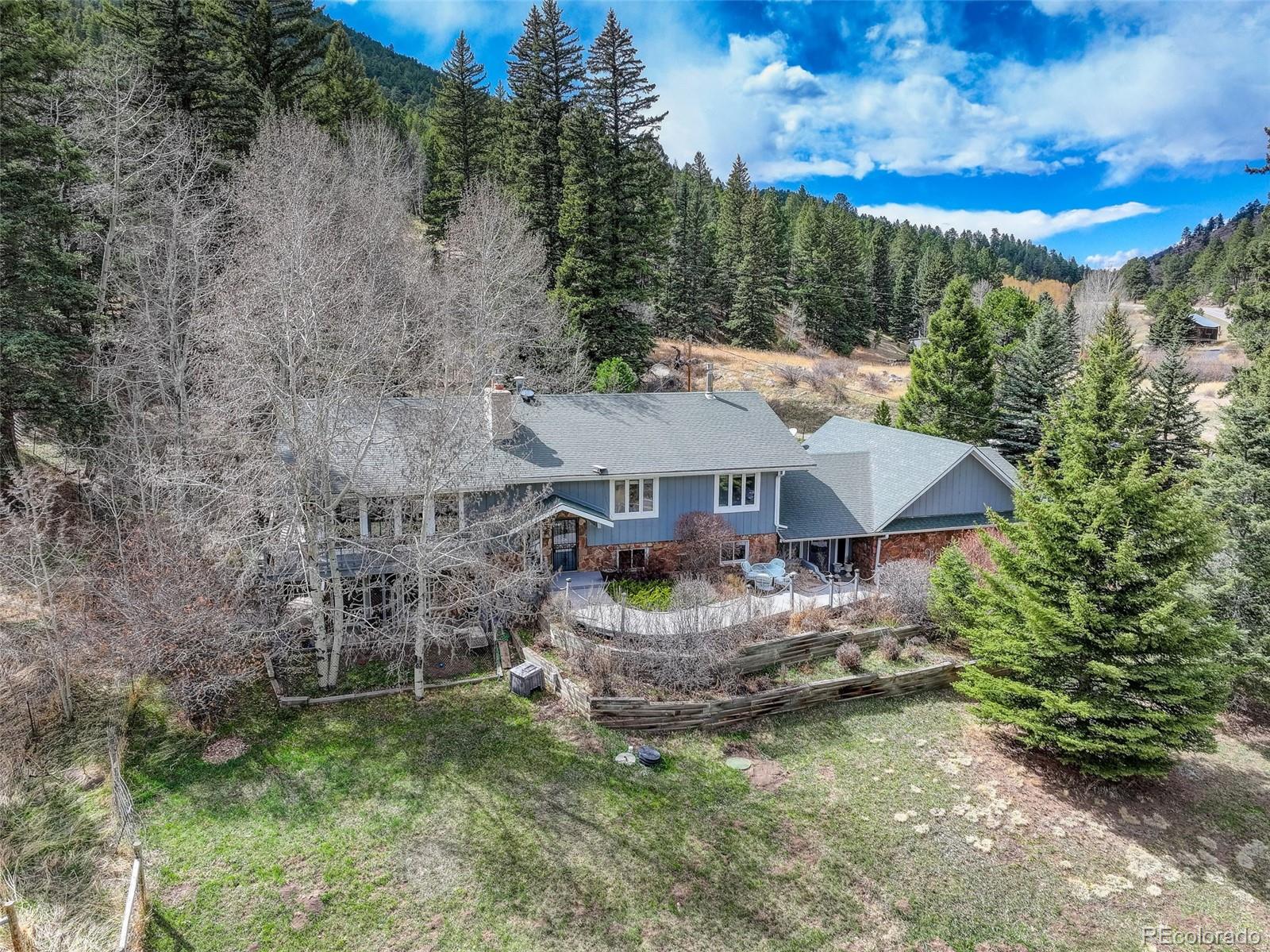 12699 South Foxton Road Conifer, CO 80433 - Photo 39 of 40 a view of a house with a big yard and large trees