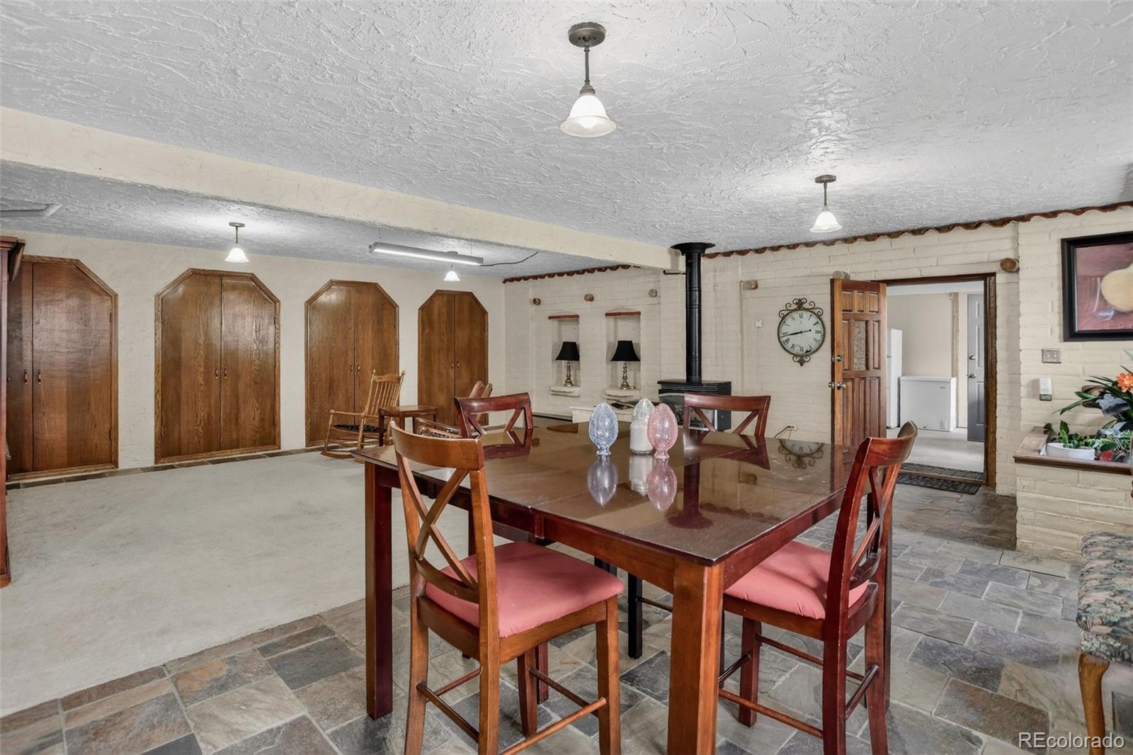 12699 South Foxton Road Conifer, CO 80433 - Photo 10 of 40 a view of a dining room with furniture and a chandelier
