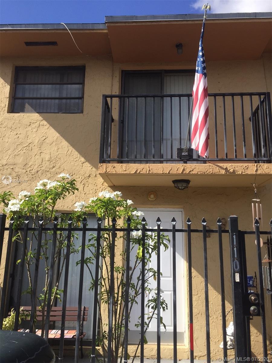 6345 Southwest 138th Court, Unit 110 Miami, FL 33183 - Photo 1 of 13 a view of a house with a wooden fence