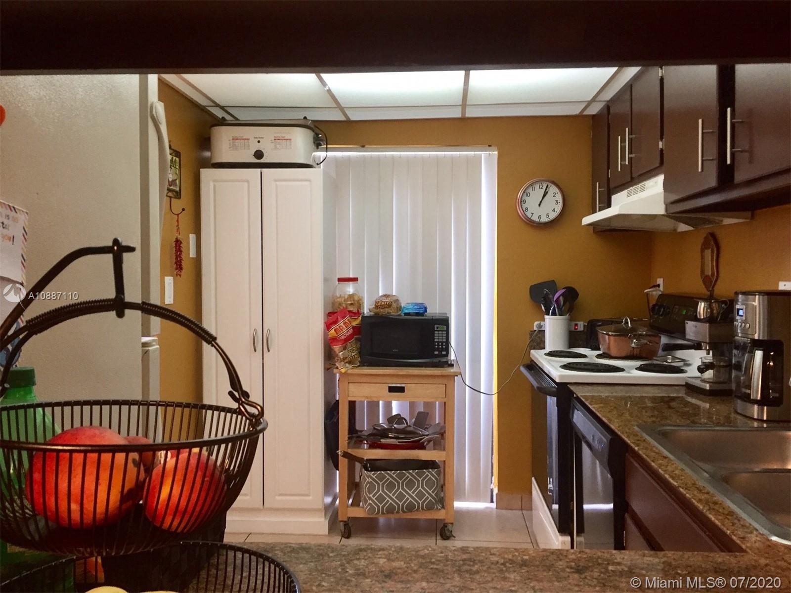 6345 Southwest 138th Court, Unit 110 Miami, FL 33183 - Photo 3 of 13 a kitchen with stainless steel appliances granite countertop a stove a sink and a refrigerator