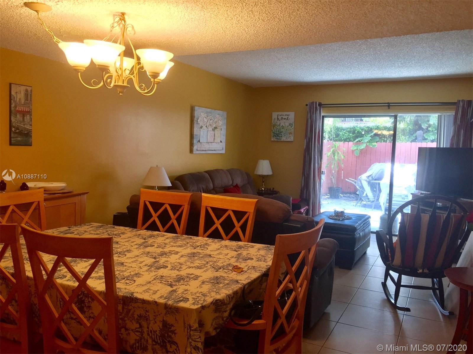 6345 Southwest 138th Court, Unit 110 Miami, FL 33183 - Photo 5 of 13 a view of a dining room with furniture window and outside view