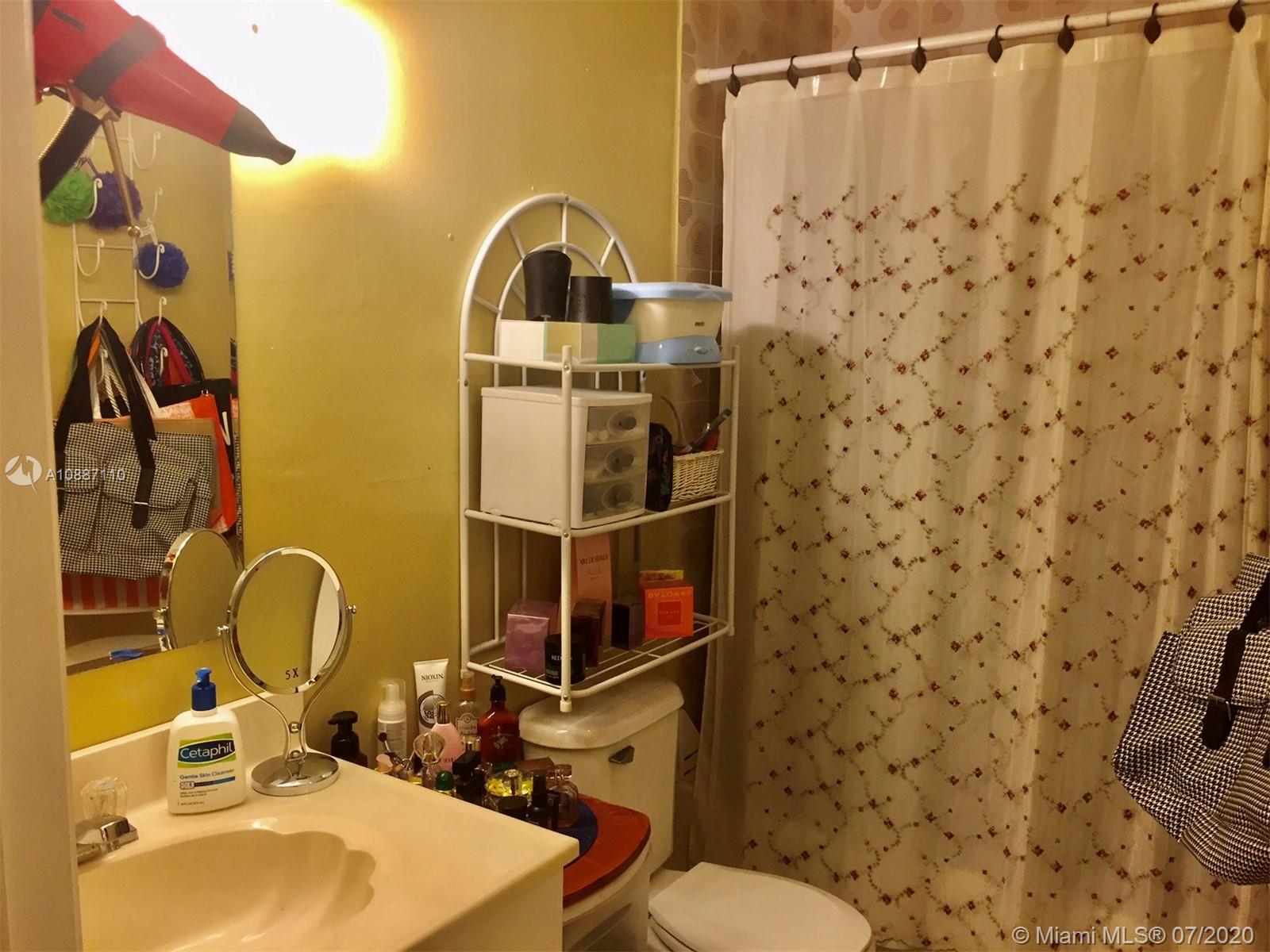 6345 Southwest 138th Court, Unit 110 Miami, FL 33183 - Photo 6 of 13 a bathroom with a sink toilet and shower