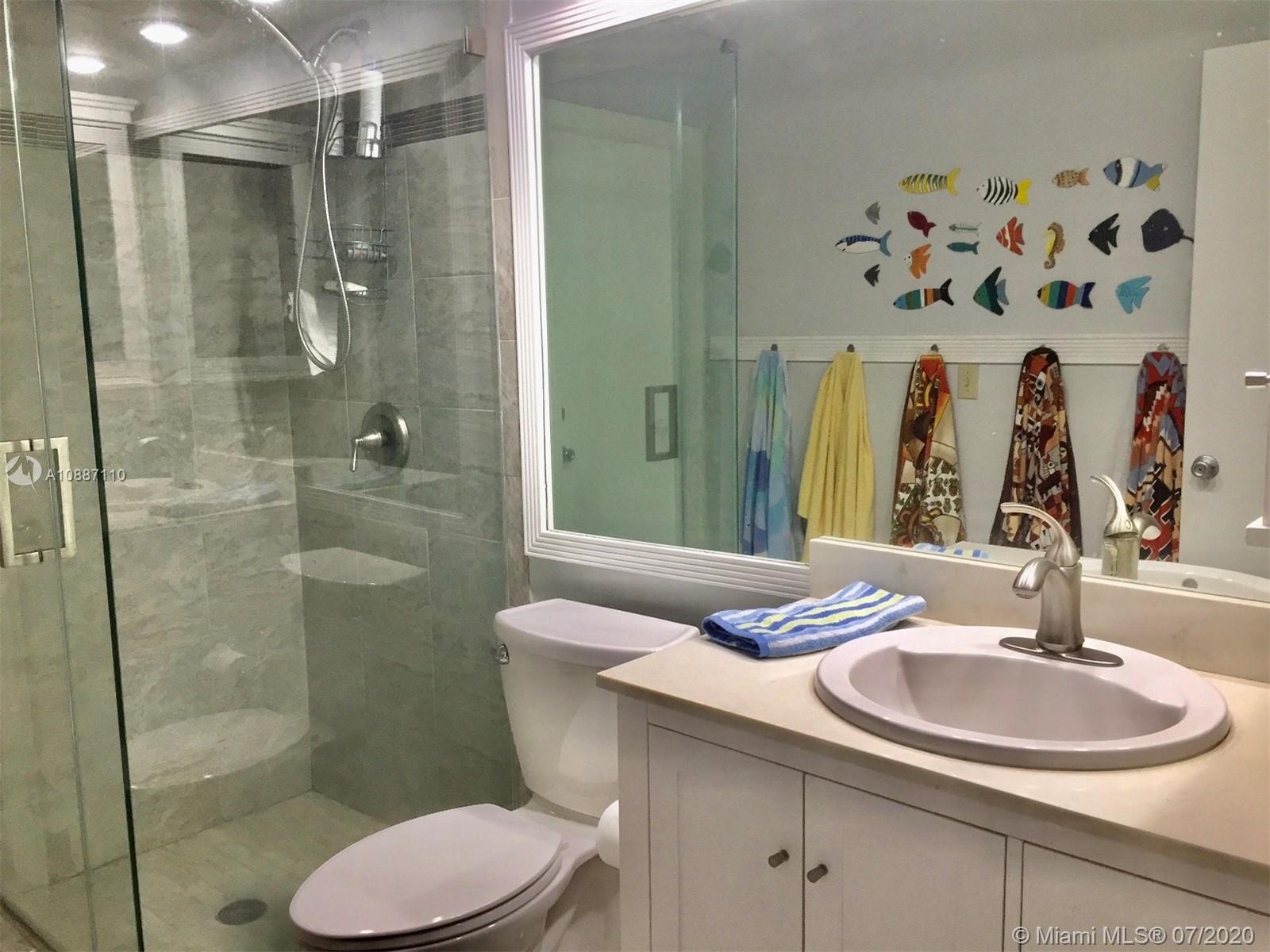 6345 Southwest 138th Court, Unit 110 Miami, FL 33183 - Photo 7 of 13 a bathroom with a sink toilet and shower