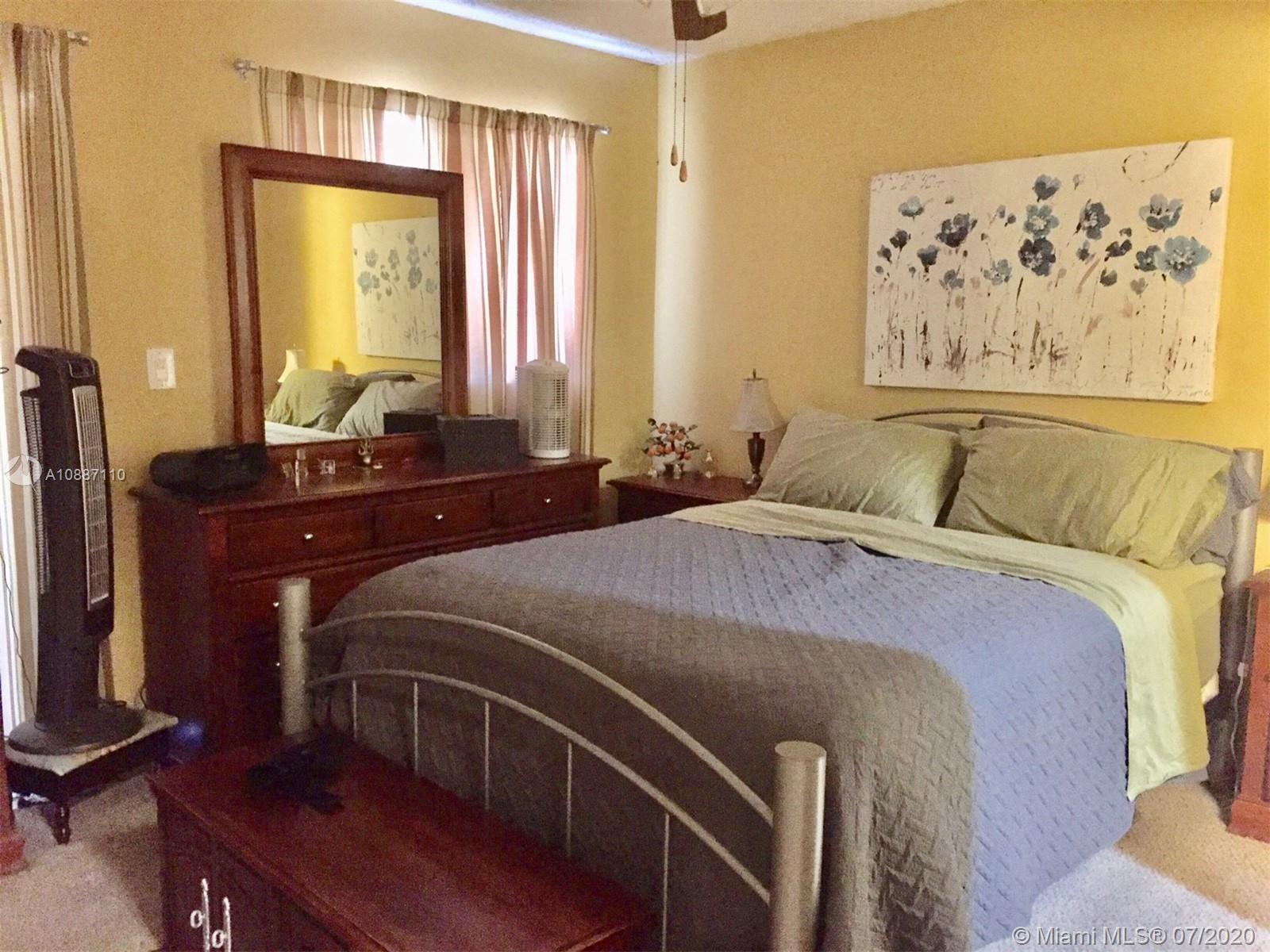 6345 Southwest 138th Court, Unit 110 Miami, FL 33183 - Photo 8 of 13 a bedroom with a bed and a desk