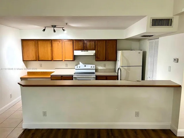 a kitchen with a sink a window and cabinets