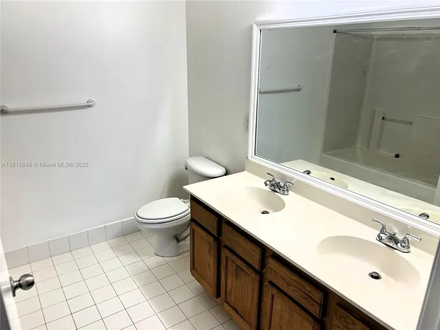 a bathroom with a sink toilet and mirror