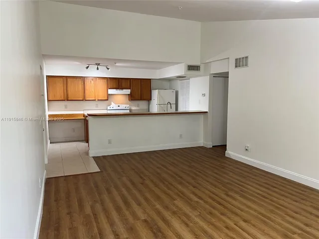 a view of cabinets and wooden floor