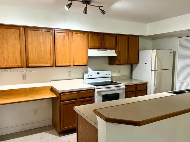 a kitchen with stainless steel appliances a stove a refrigerator and a sink