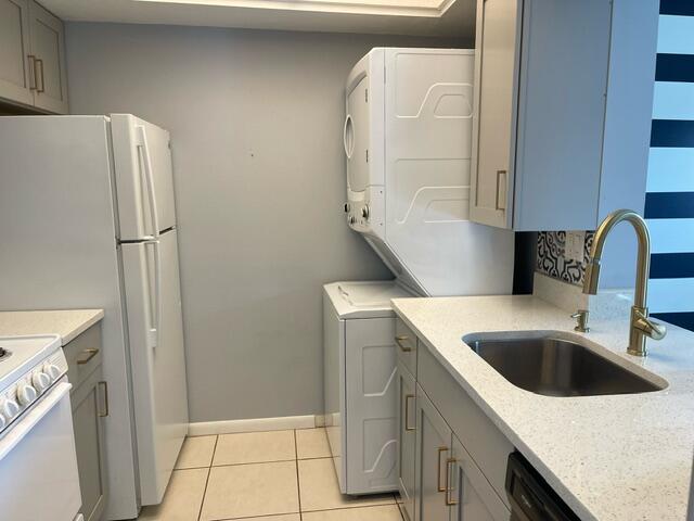 1180 Carlton Court, Unit 204B Fort Pierce, FL 34949 - Photo 11 of 19 a kitchen with a refrigerator and a sink